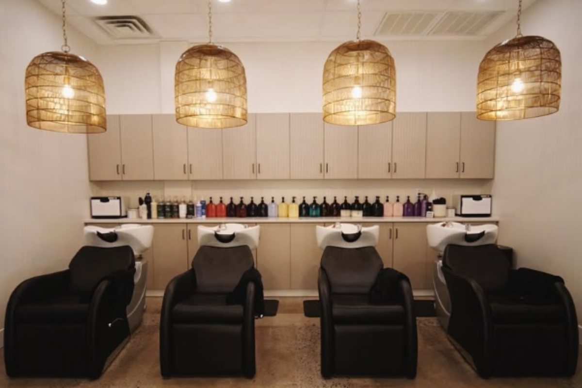 The shampoo room at Salon Rooted consists of 4 very comforatable reclining chairs and paded shampoo sinks with a full selection of Oribe shampoos and conditoners
