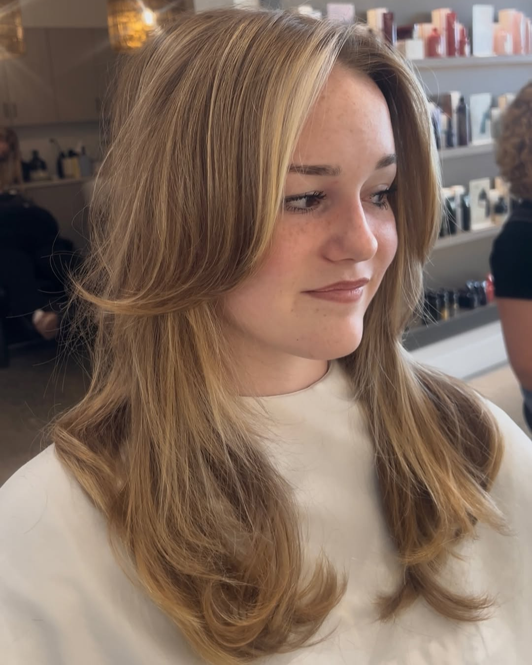 Honey Blonde Layered Haircut with Curtain Bangs